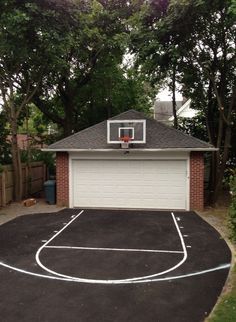 a basketball court in front of a house