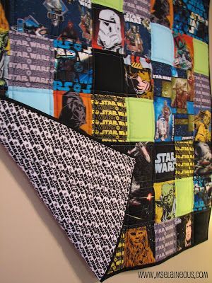 a star wars themed quilt hanging on the wall