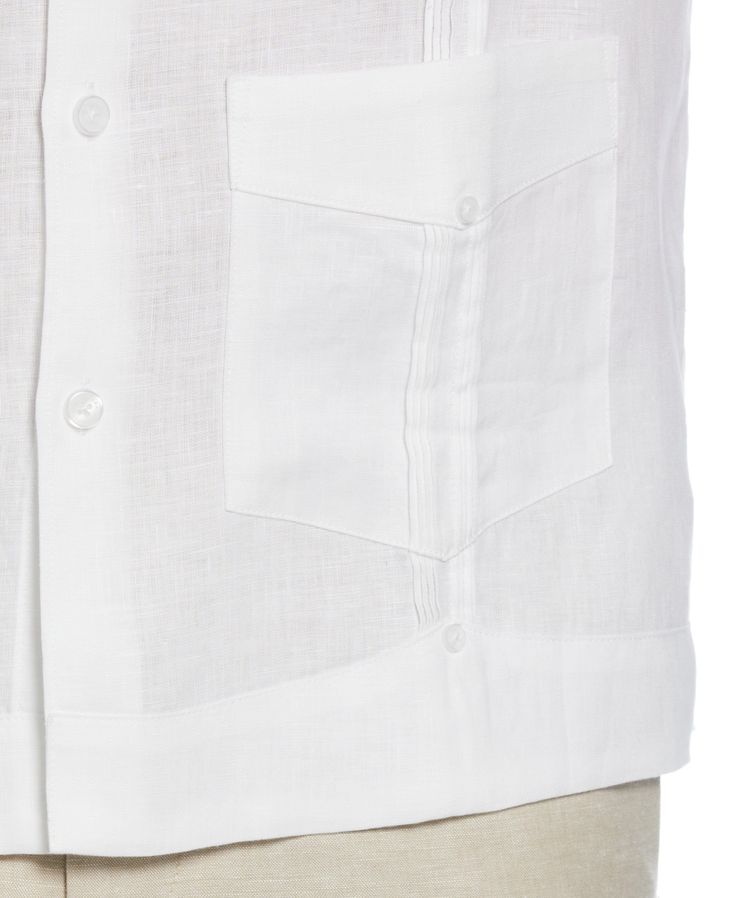 This Cubavera men's short sleeve guayabera is a classic blend of comfort and style. Crafted from 100% durable, plain weave linen, it features short sleeves and the traditional four-pocket design. This button-up dress shirt encapsulates timeless guayabera styling, making it a versatile addition to any wardrobe. The perfect fusion of tradition and elegance, this shirt effortlessly elevates your casual or formal looks. 100% Linen Classic Fit Plain Weave Fabrication Weaves In Criss-Cross Patterning White Camp Shirt With Pockets And Camp Collar, White Short Sleeve Shirt With Camp Collar And Pockets, White Linen Camp Shirt With Pockets, White Short Sleeve Shirt With Patch Pockets, White Short Sleeve Shirt With Pockets And Camp Collar, White Short Sleeve Shirt With Spread Collar And Pockets, White Short Sleeve Shirt With Pockets And Spread Collar, Classic Summer Camp Shirt With Pockets, White Classic Short Sleeve Shirt With Camp Collar