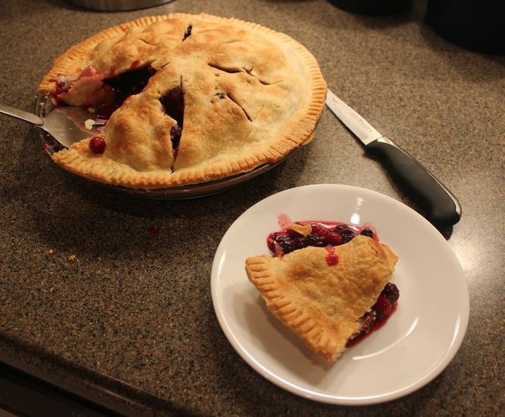 two pies sitting on top of a counter next to each other with one slice missing