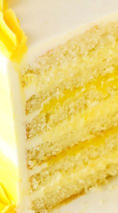 a slice of yellow cake sitting on top of a white plate