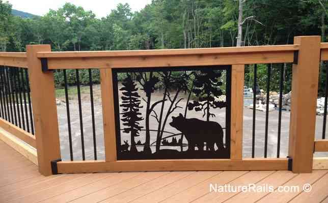 a bear and cub metal artwork on a wooden deck with trees in the back ground