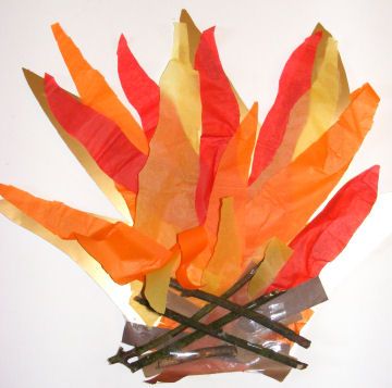 an arrangement of orange, yellow and red paper leaves with sticks sticking out of them