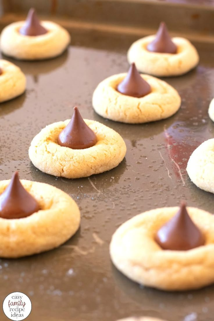 some cookies with chocolate on them sitting on a pan