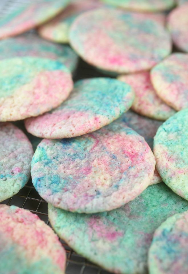 colorful cookies are on a cooling rack ready to be eaten