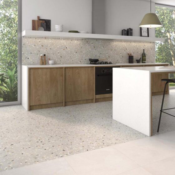 a modern kitchen with an island countertop and bar stools