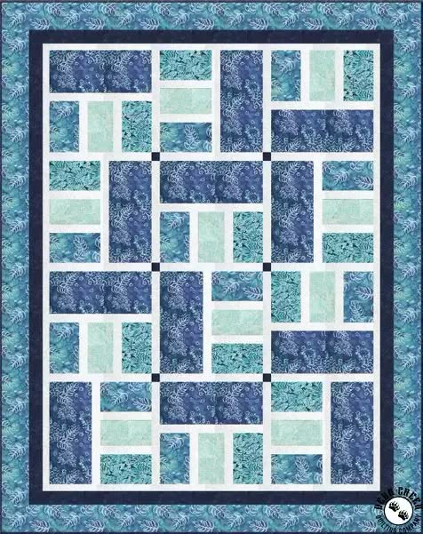 a blue and white quilt with squares on the front, one block in the middle