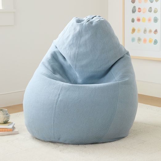 a blue bean bag chair sitting on top of a white rug