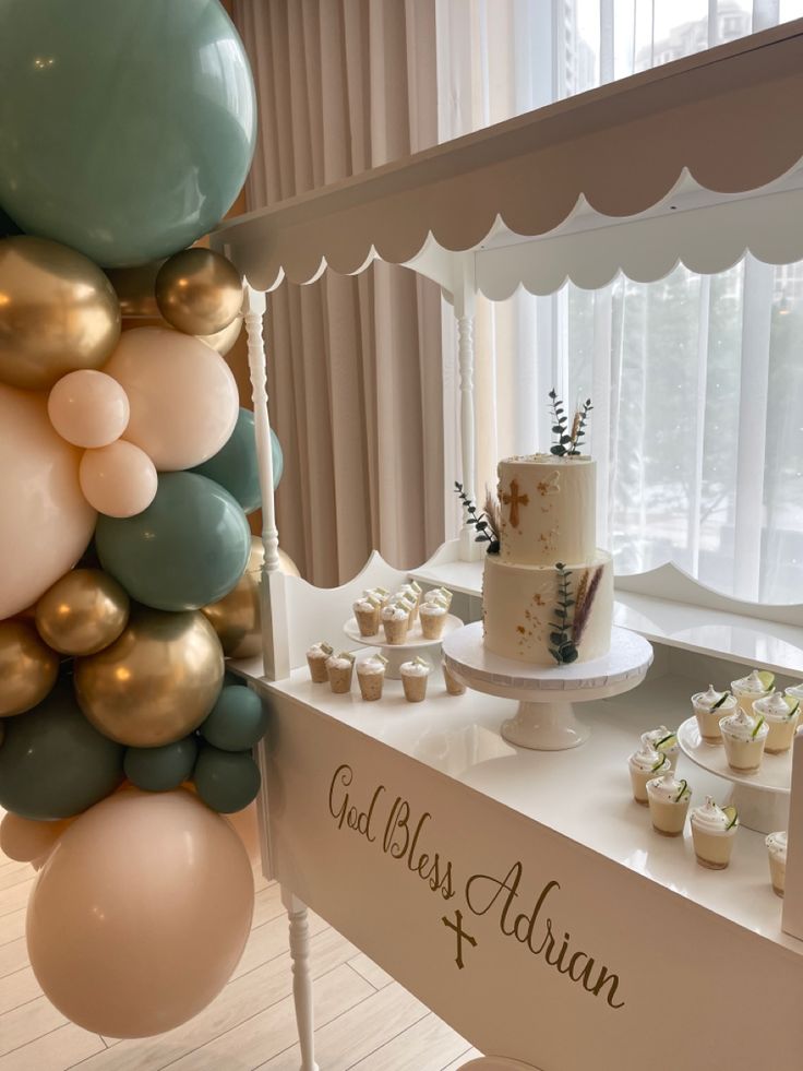 a table topped with lots of balloons and cake