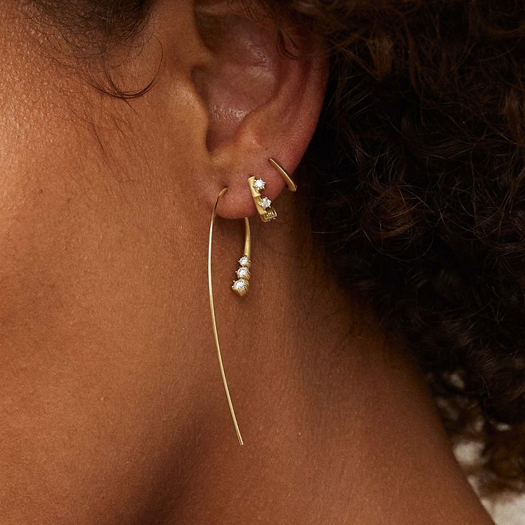 The Clara Mini Huggie Earrings feature 3 brilliant-cut diamonds mounted in our signature six-prong setting and angular Clara detailing. Handcrafted in 18-karat gold, the combination of our matte finish and knife-edge technique bring a modern feel to these everyday earrings. We love pairing these buggies with similar diamond pieces like the Single Stone Huggies and the Kismet Mini Huggies for a wearable everyday diamond look. MATERIALS & MEASUREMENTS Handcrafted in 18-Karat Gold 0.20 total carat Ear Stack, Single Stone, Huggie Earrings, Everyday Earrings, Huggies Earrings, Three Stone, Brilliant Cut Diamond, Round Brilliant, Prong Setting