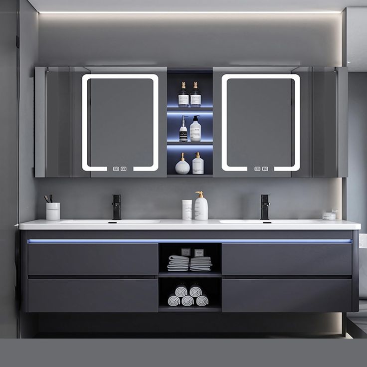 a modern bathroom with two sinks and mirrors