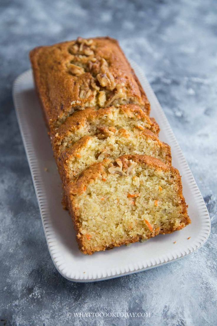 a loaf of carrot bread sitting on top of a white plate