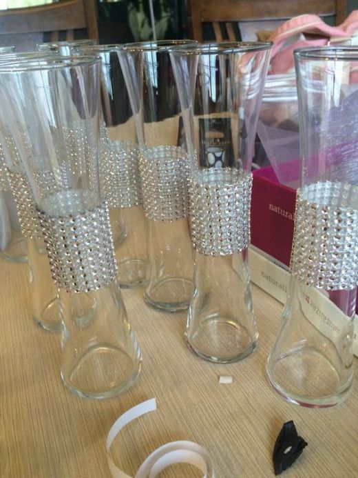 several clear glass vases sitting on top of a table