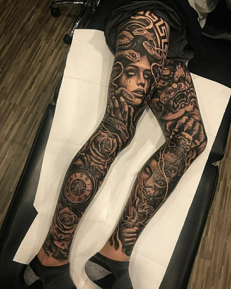 a person laying on top of a bed with tattoos on their arms and legs