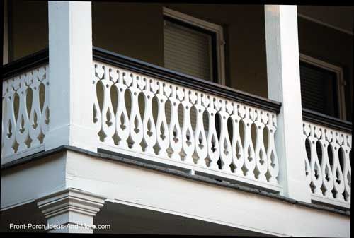 a balcony with white balconies and wrought iron railing