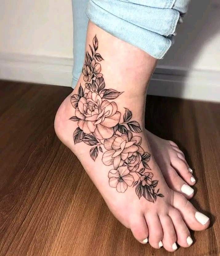 a woman's foot with flowers on it