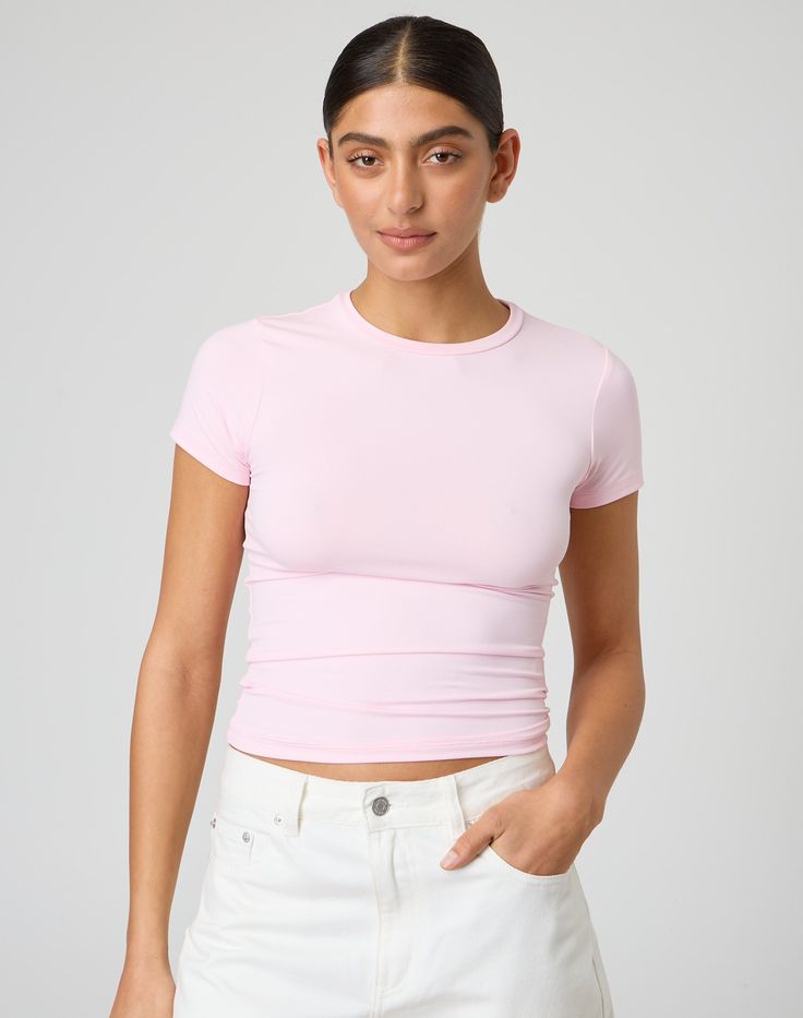 This jersey style t-shirt features supersoft material, short sleeves and a long line length. Minimal Stretch Spring Tops In Athleisure Style, Spring Sporty Tops With Shirttail Hem, Sporty Spring Tops With Shirttail Hem, Fitted Pink Short Sleeve T-shirt, Basic Short Sleeve Tops For Layering, Versatile Crew Neck T-shirt With Minimal Stretch, Trendy Spring T-shirt With Shirttail Hem, Trendy Shirttail Hem T-shirt For Spring, Spring Athleisure Stretch T-shirt