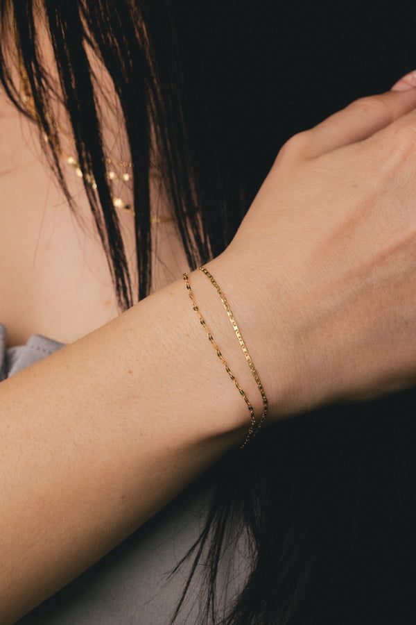 A beautiful, elegant, and contemporary design. This bracelet is meticulously crafted using 14K yellow gold. More layers means more variety! Glisten in this Valentino and Hammered Forzentina Chain. BRACELET DETAILS: -Weight: 1.2 grams - Length: 7.5" -Clasp Type: Pear Shape Lobster Available in: 14K yellow gold ****These necklaces have a 4-week lead time. If you need your necklace sooner than that, please contact us prior to ordering to verify if that's possible.** | Valentino & Hammered Forzentin Classic Hammered Yellow Gold Bracelets, Elegant Hammered Yellow Gold Bracelet, Hammered Yellow Gold Plated Bracelets, Elegant Hammered Gold-plated Bracelets, Delicate 14k Gold-filled Yellow Gold Bracelets, Staghead Designs, Layered Bracelets, Pear Shaped, Yellow Gold Rings