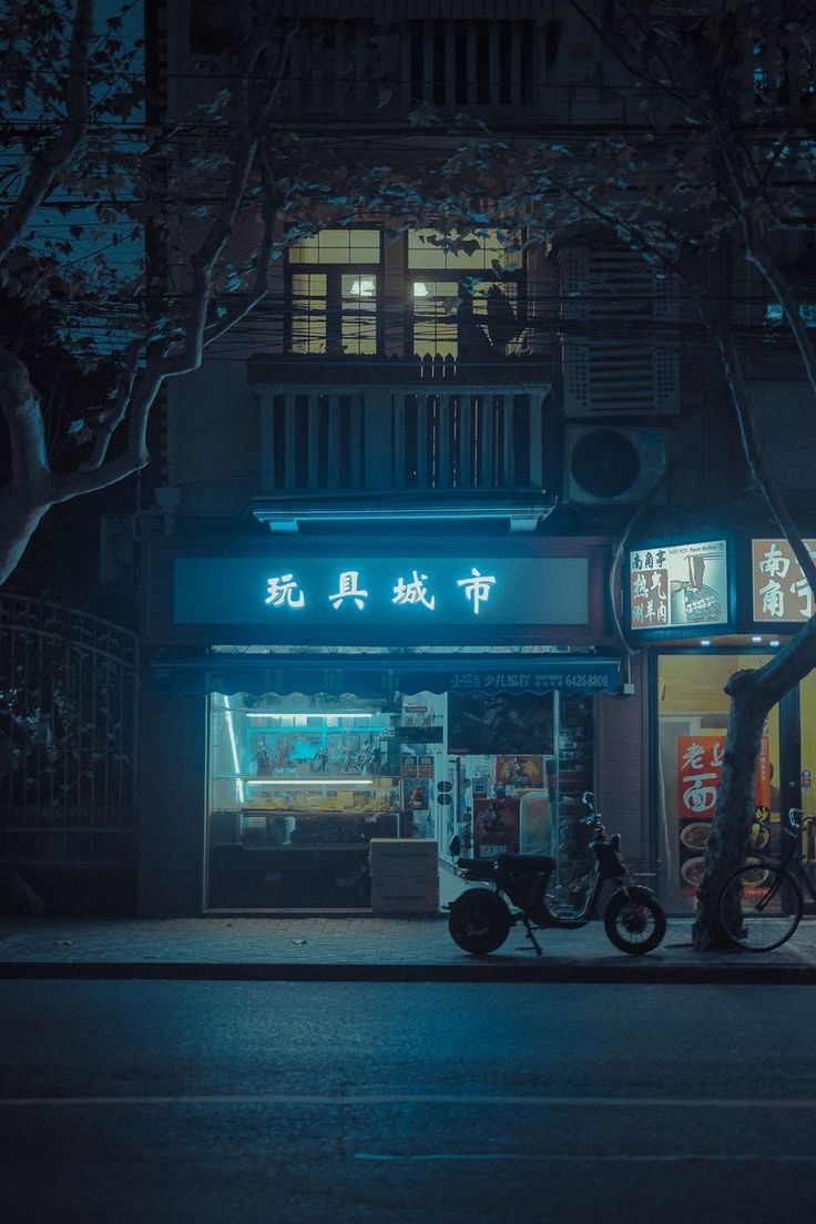 a motorcycle parked in front of a store at night