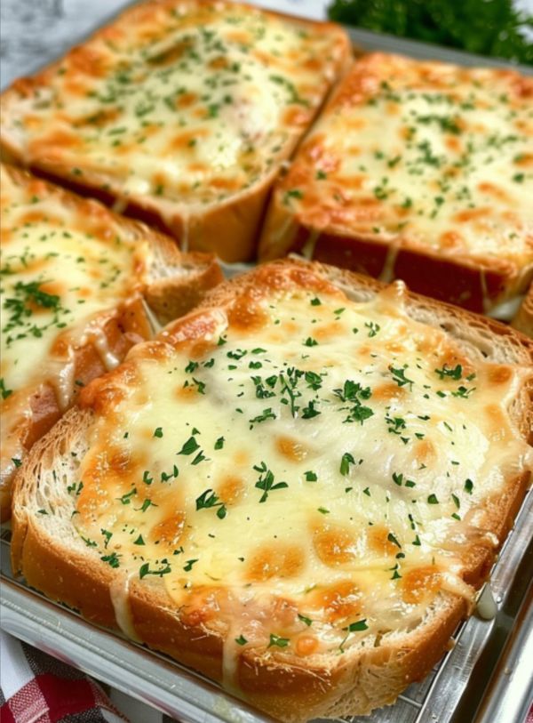 several slices of bread with cheese and parsley on top