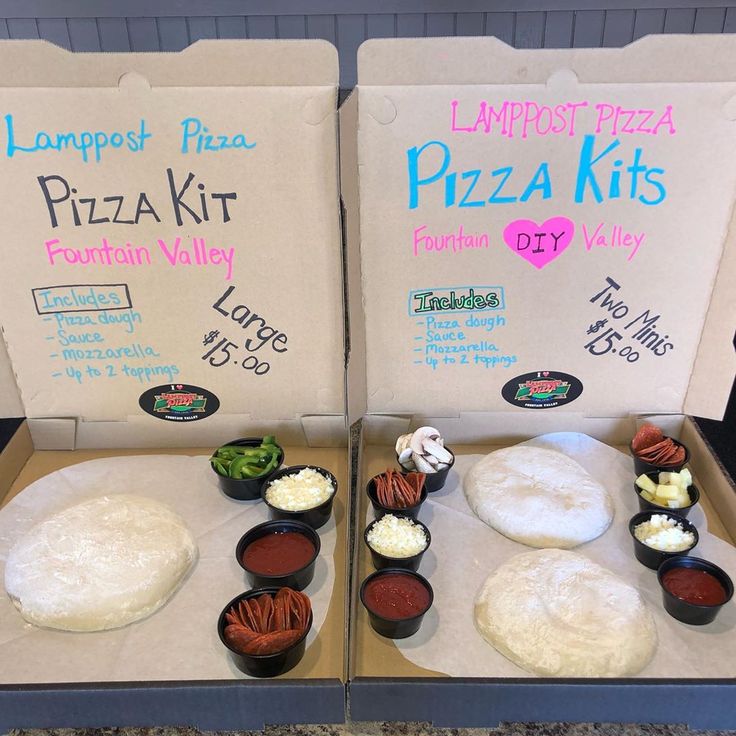 two pizza boxes with different types of toppings