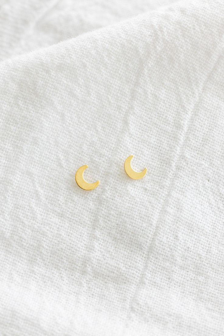 14k gold filled 6mm moon studs Please note that due to the handmade nature of this piece, they will vary slightly in appearance. There may also be slight color variations from soldering where the post meets the earrings, which is totally normal! Sold as a pair and comes with backings Gold filled is a soft metal so when putting the backings on and taking them off, hold the base of the post to avoid any bending Please note: all earrings are final sale Minimalist Handmade Gold Cartilage Earrings, Gold Minimalist Handmade Cartilage Earrings, Dainty Gold Crescent Cartilage Earrings, Gold Crescent Cartilage Earrings Nickel Free, Minimalist Gold Crescent Cartilage Earrings, Gold Cartilage Earrings With Moon Charm For Gift, Gold Moon Cartilage Earrings, Gold Round Cartilage Earrings With Moon Charm, Minimalist Gold Moon Earrings