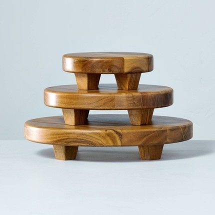 three wooden stools stacked on top of each other