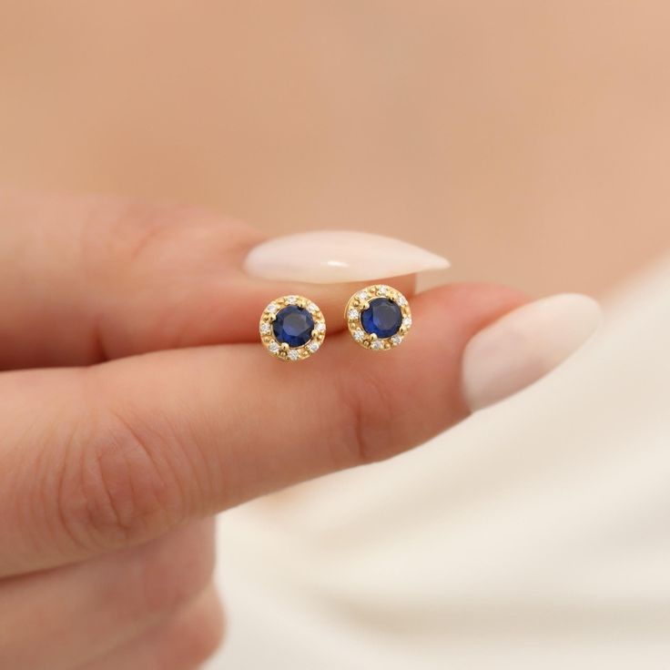 Indulge in the timeless elegance of our 14K Solid Gold Real Diamond Round Stud Earrings featuring the stunning Sapphire, the birthstone for September. These exquisite earrings showcase a mesmerizing blue Sapphire, known for its breathtaking depth and brilliance. Each Sapphire is nestled in a setting of 14K solid gold, providing a classic and luxurious backdrop that enhances the gemstone's natural beauty. Accented with small genuine diamonds, these earrings offer just the right touch of sparkle, Gold Cubic Zirconia Earrings With Gemstones, Gold Plated Diamond Earrings For Gift, Yellow Gold Gemstone Diamond Earrings Gift, Gold Diamond Gemstone Earrings For Gifts, Gold Gemstone Diamond Earrings For Anniversary, Gold Diamond Gemstone Earrings For Anniversary, Formal Round Diamond Earrings With Birthstone, Gold Plated Round Diamond Earrings As Gift, Sapphire Earrings With Halo Setting For Gift