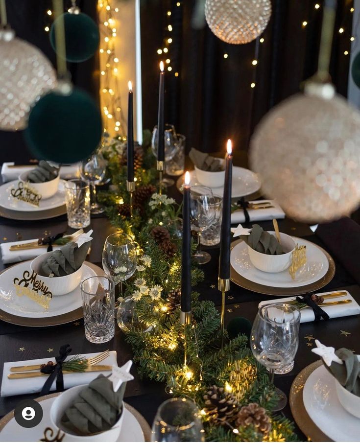 the table is set for christmas dinner with candles