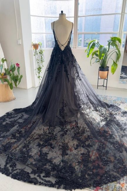 a black wedding dress on display in a room