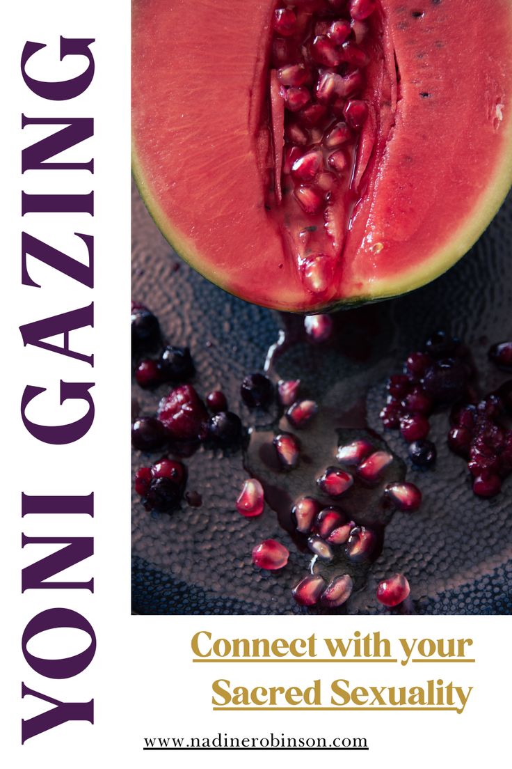 a piece of watermelon sitting on top of a table next to pomegranates