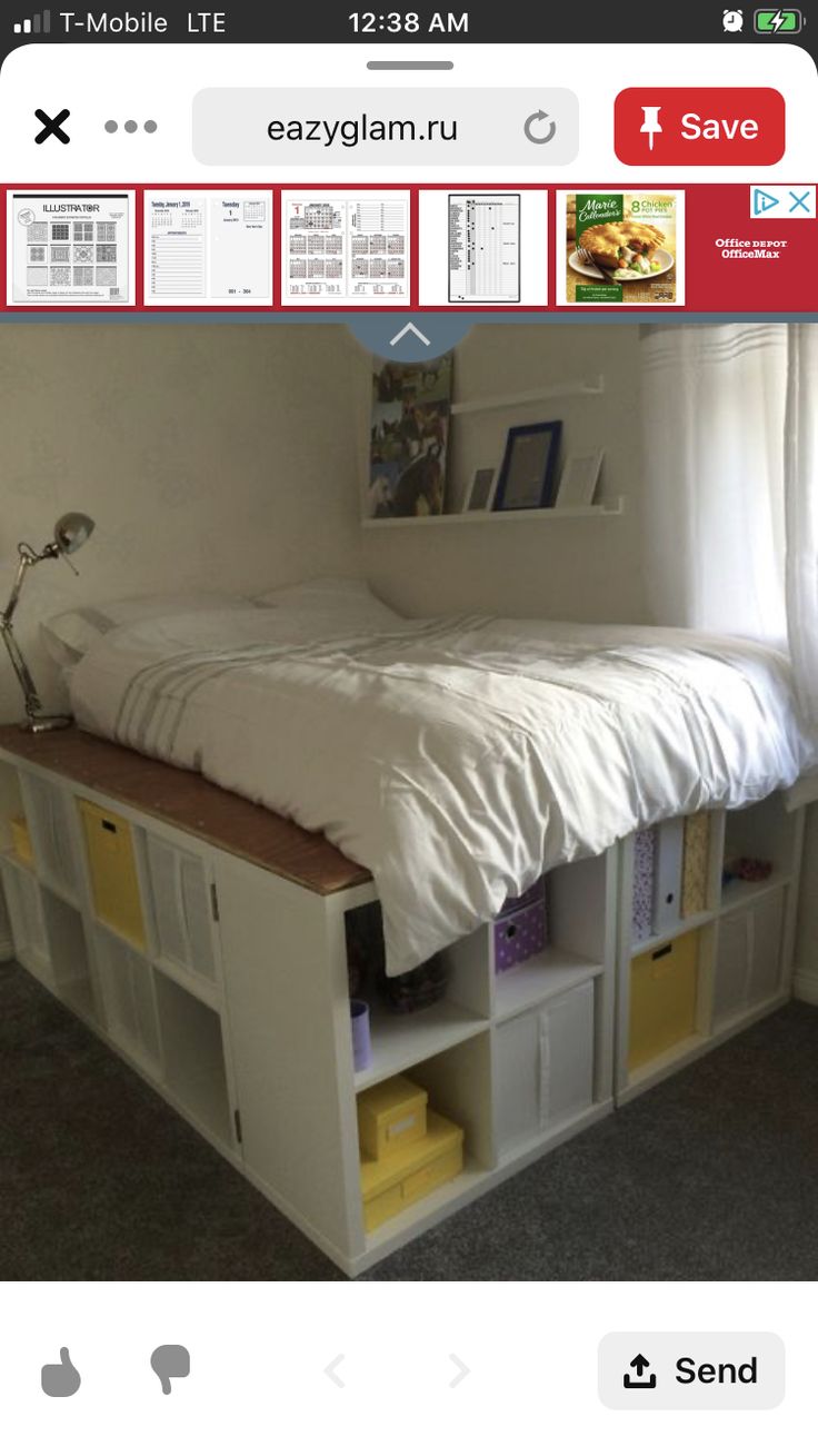 a bed sitting on top of a white shelf next to a window