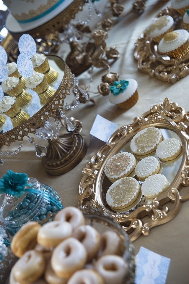 a table topped with lots of different types of cookies and pastries on top of plates