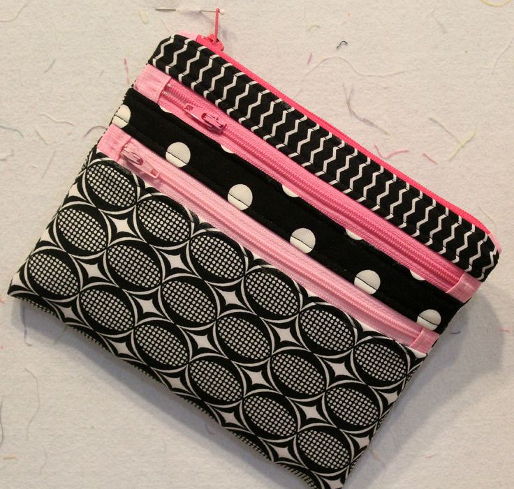 three zippered pouches sitting on top of each other