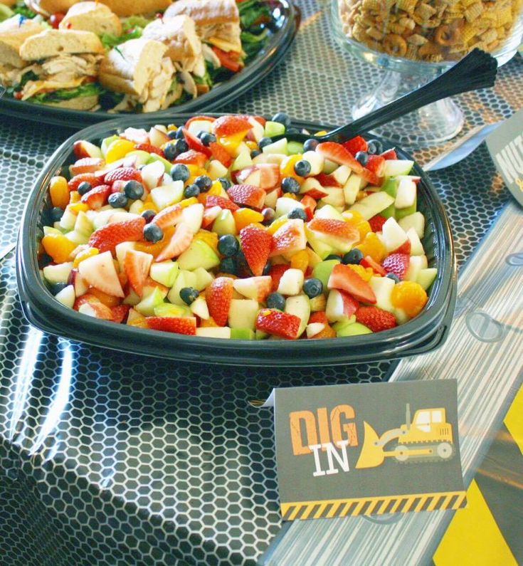 a table topped with plates of food and serving utensils on top of it