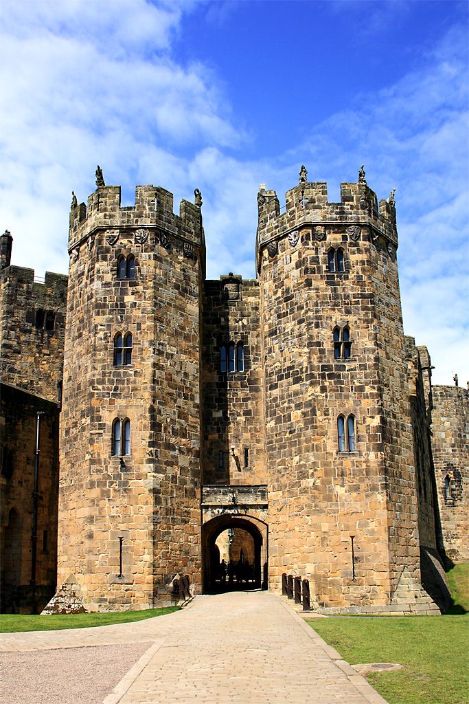 the entrance to an old castle on a sunny day