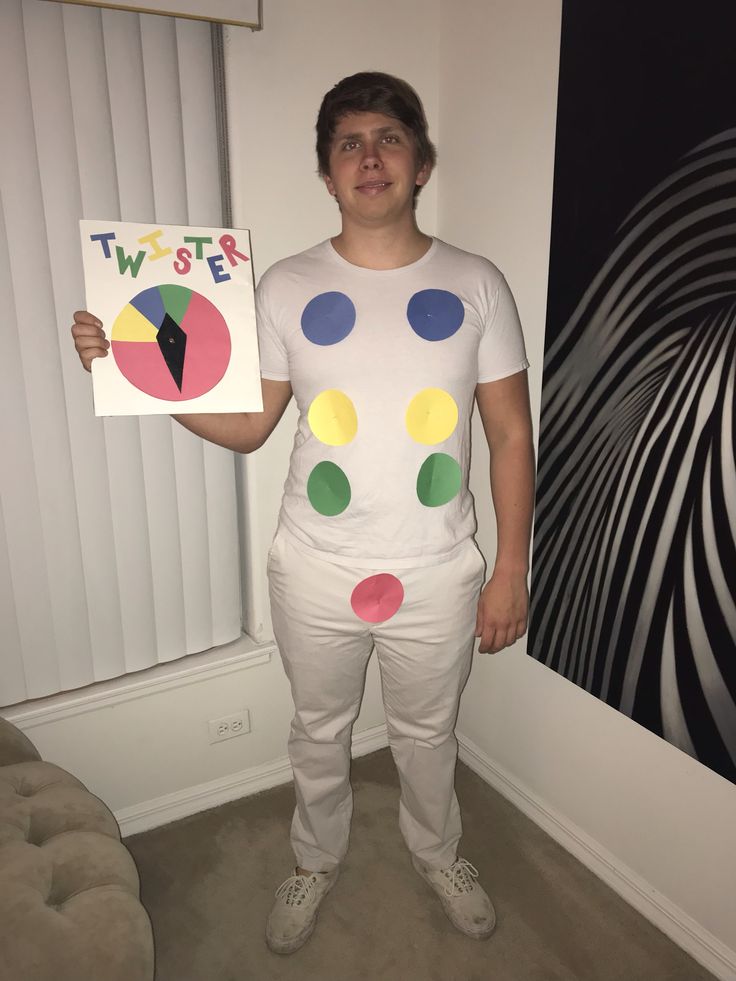 a man is dressed up as a clown holding a t - shirt with circles on it