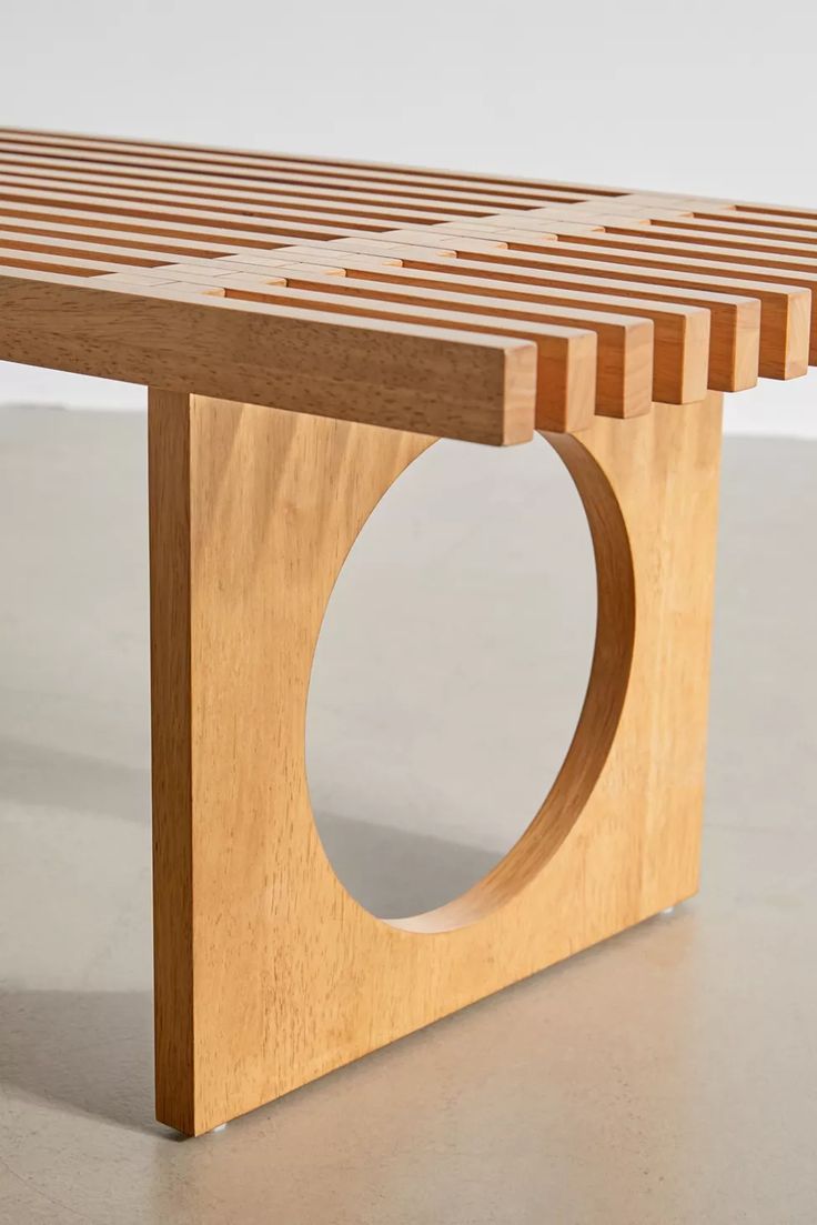 a wooden bench with a circular hole in the center on top of it's sides