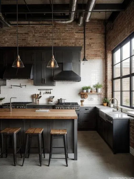 an industrial style kitchen with black cabinets and stools