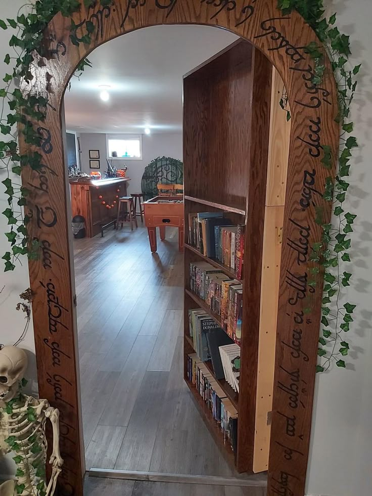 a wooden arch with writing on it in the middle of a room filled with books