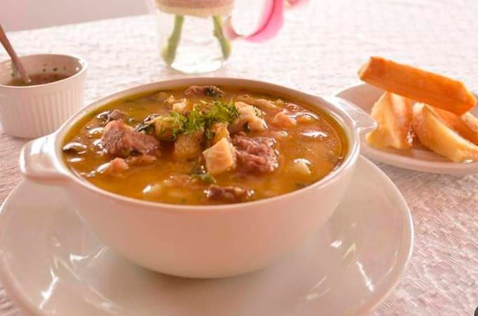 a bowl of soup on a white plate