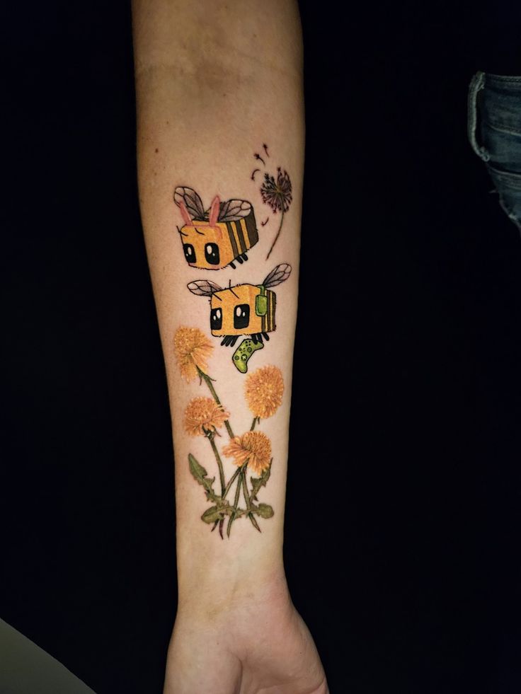 a person with a tattoo on their arm that has flowers and a bee on it