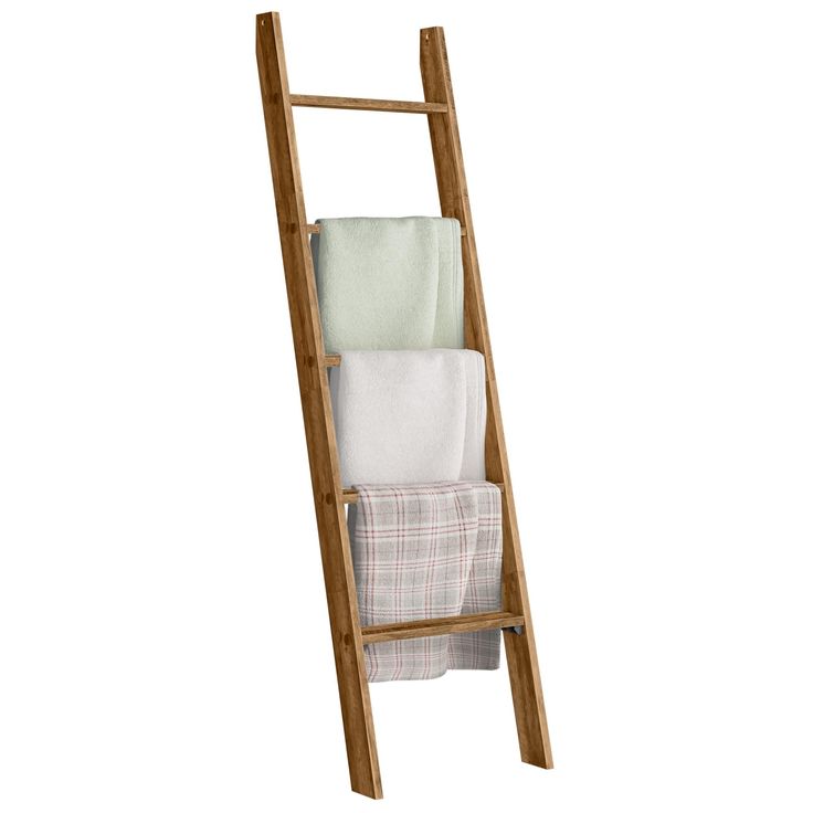 a wooden ladder holding towels and blankets on it's side, against a white background