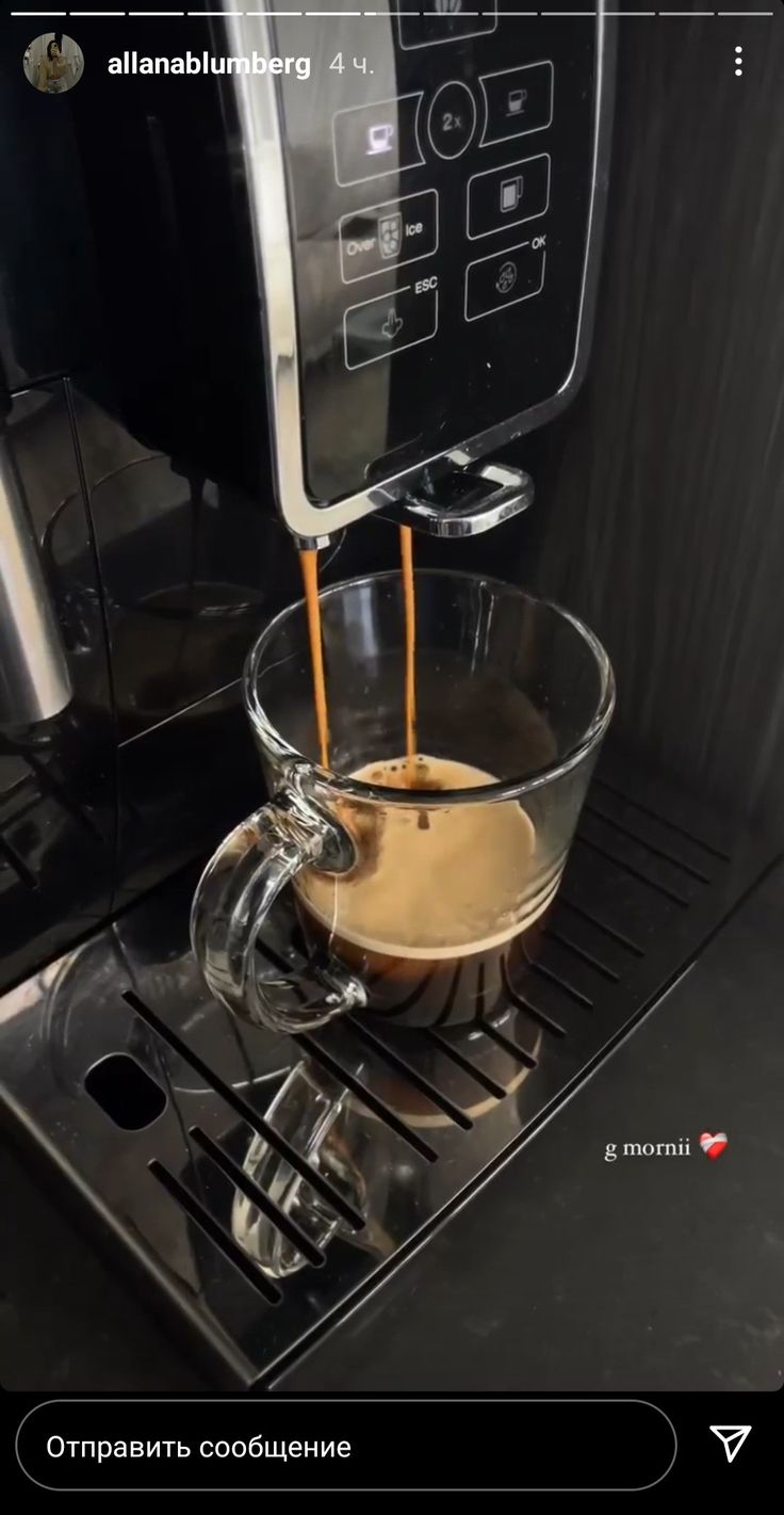 an espresso machine with liquid being poured into it