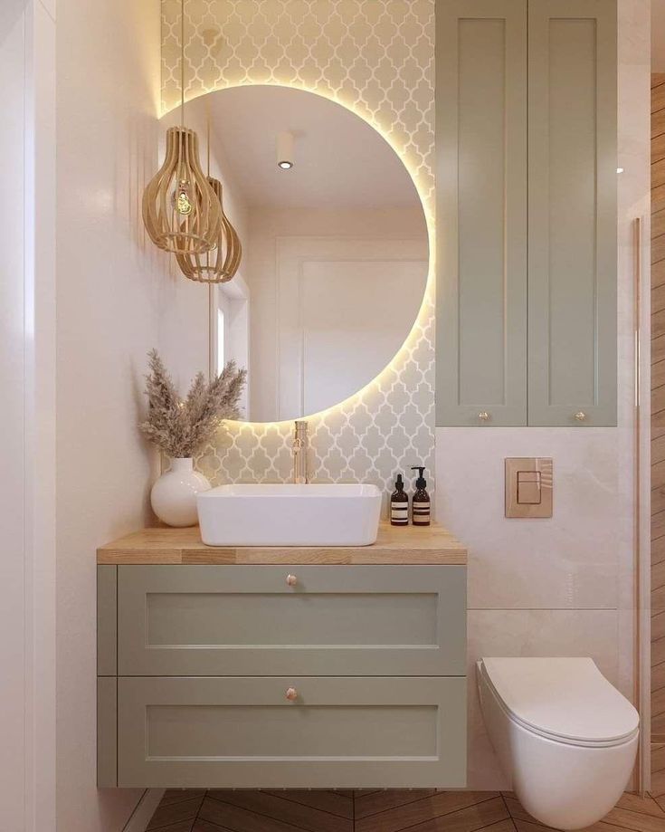 a bathroom with a white toilet and a round mirror on the wall next to it