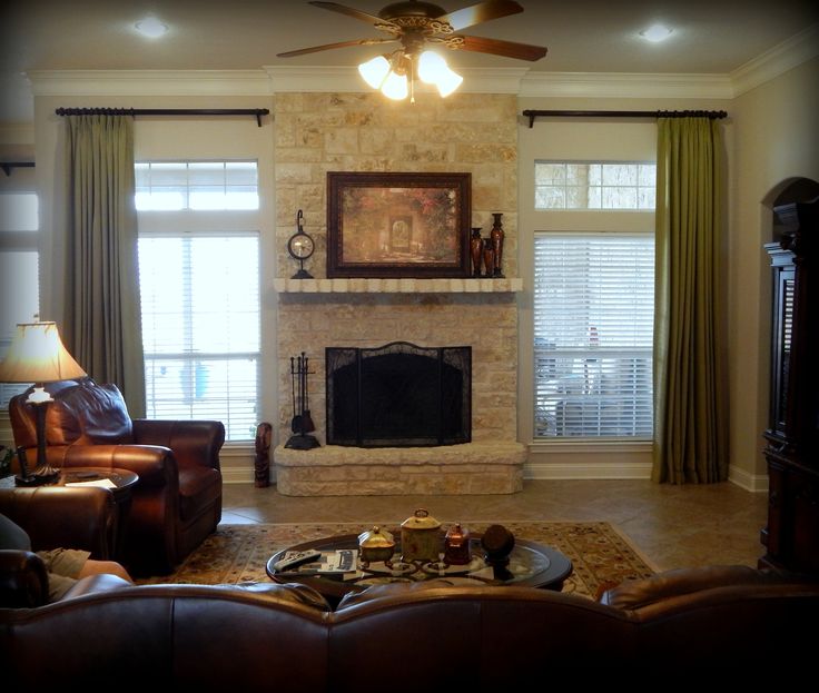 a living room filled with furniture and a fire place in front of a tv mounted on a wall