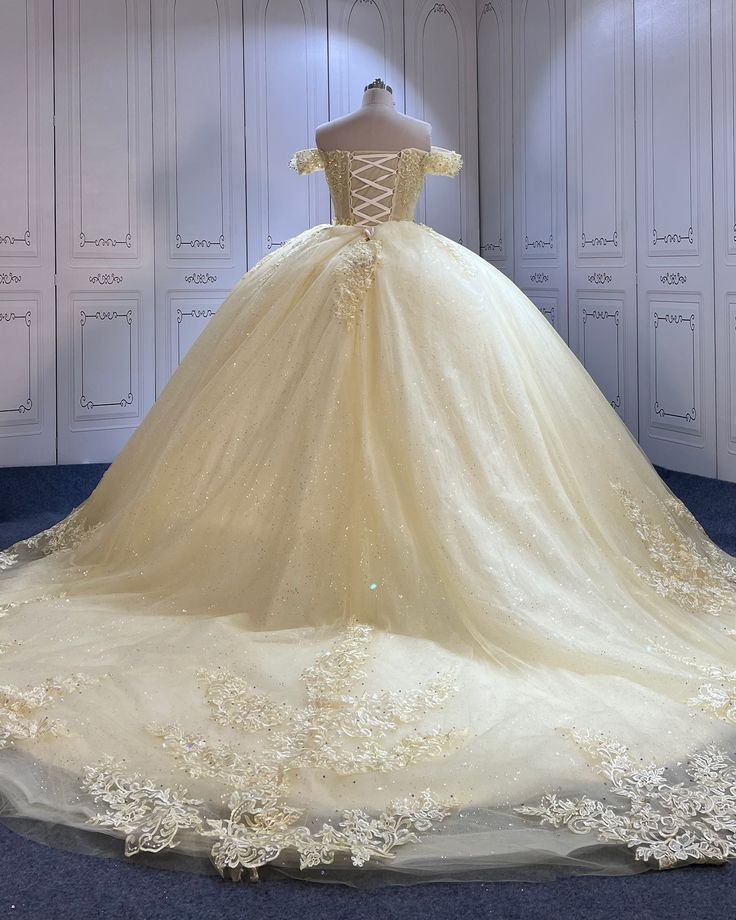 a wedding dress is displayed on a mannequin