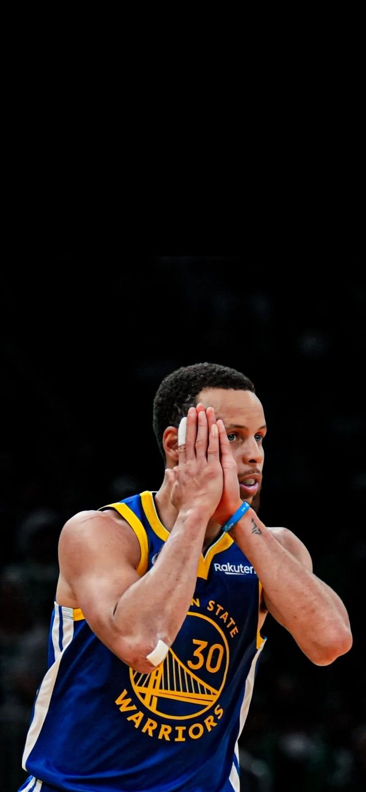 a basketball player is holding his hands up