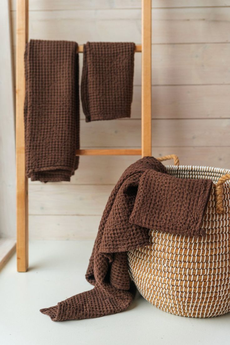 a basket with two towels hanging from it