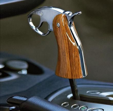 a wooden handle on the steering wheel of a car